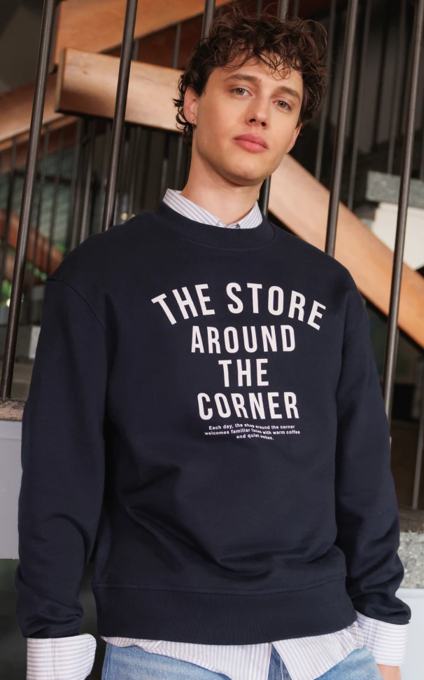 tenue homme - chemise rayée sous un sweat bleu marine